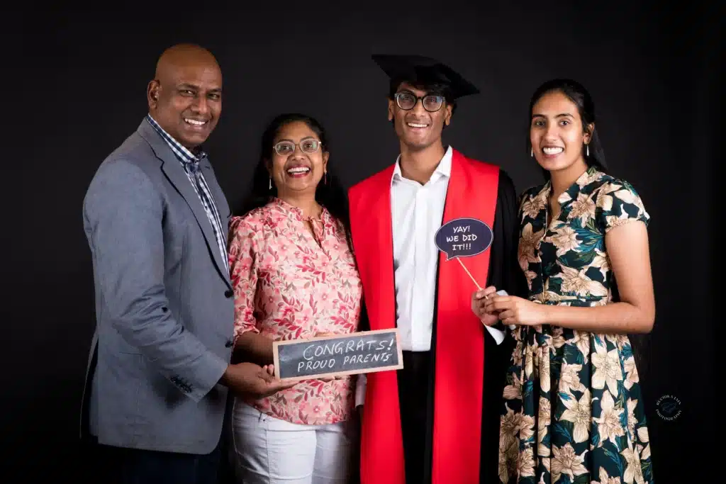 A group of graduates smiling together at their professional graduation photography session
